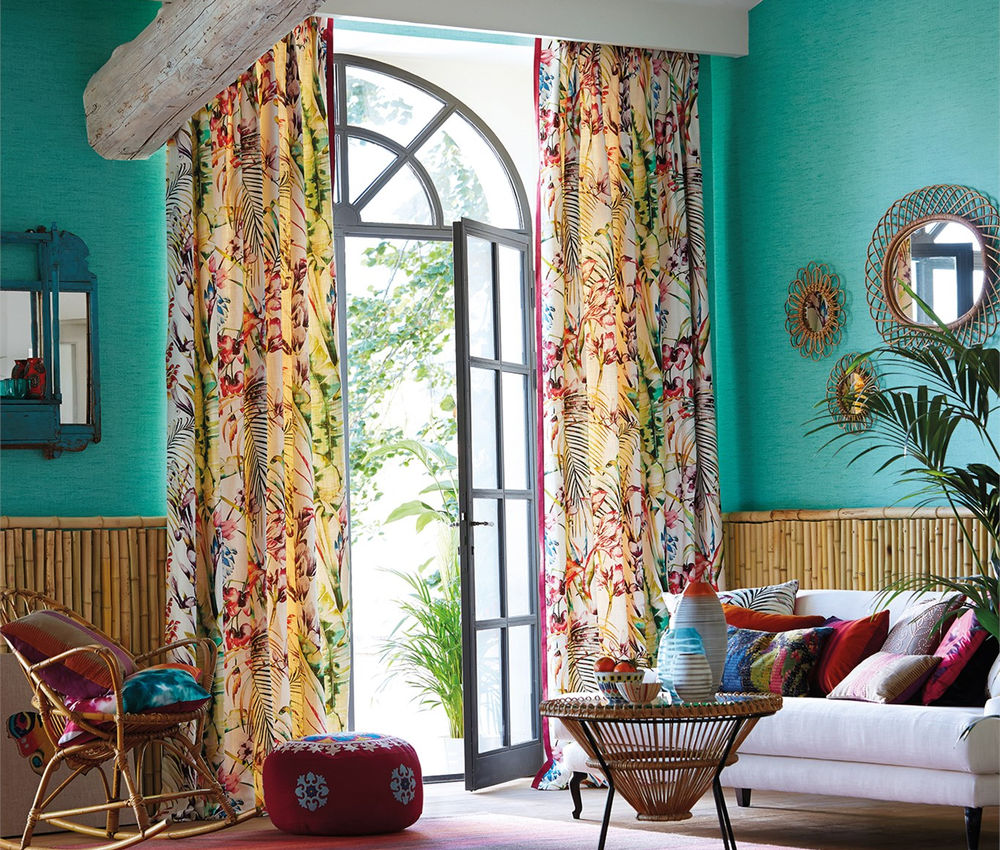 Patterned curtains framing a bright living room window