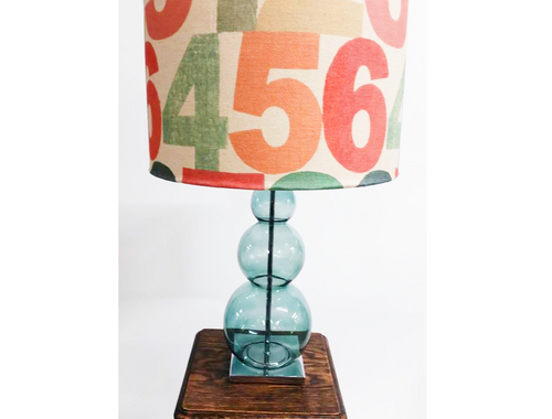 Table lamp with a colourful numbered fabric shade